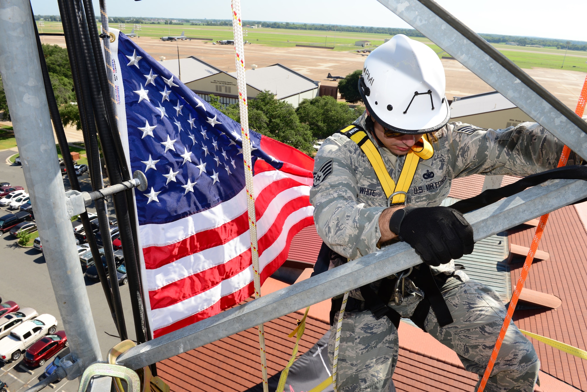 Staff Sgt. Michael White, 2nd Security Forces Squadron, moves to a new position on a communication tower on Barksdale Air Force Base, La., July 15, 2015. White held his reenlistment ceremony atop the communication tower. (U.S. Air Force Photo/Airman 1st Class Luke Hill)