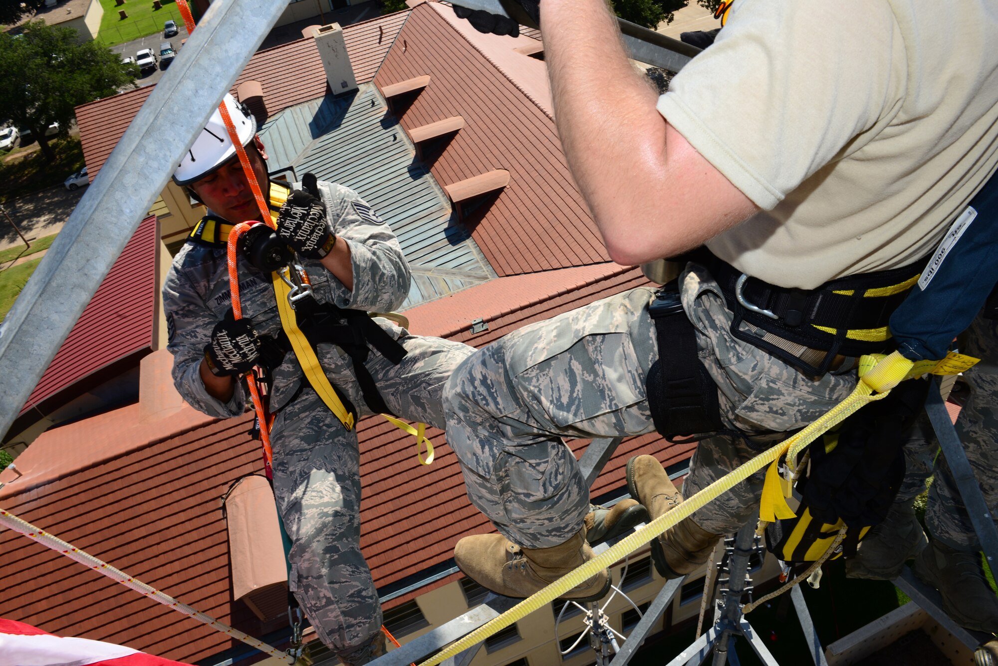 Staff Sgt. Jezrell Zimmerman, 2nd Security Force Squadron, repels down a communications tower on Barksdale Air Force Base, La., July 15, 2015. The 2nd Security Forces Squadron held a special reenlistment ceremony on top of a communication tower. (U.S. Air Force Photo/Airman 1st Class Luke Hill)