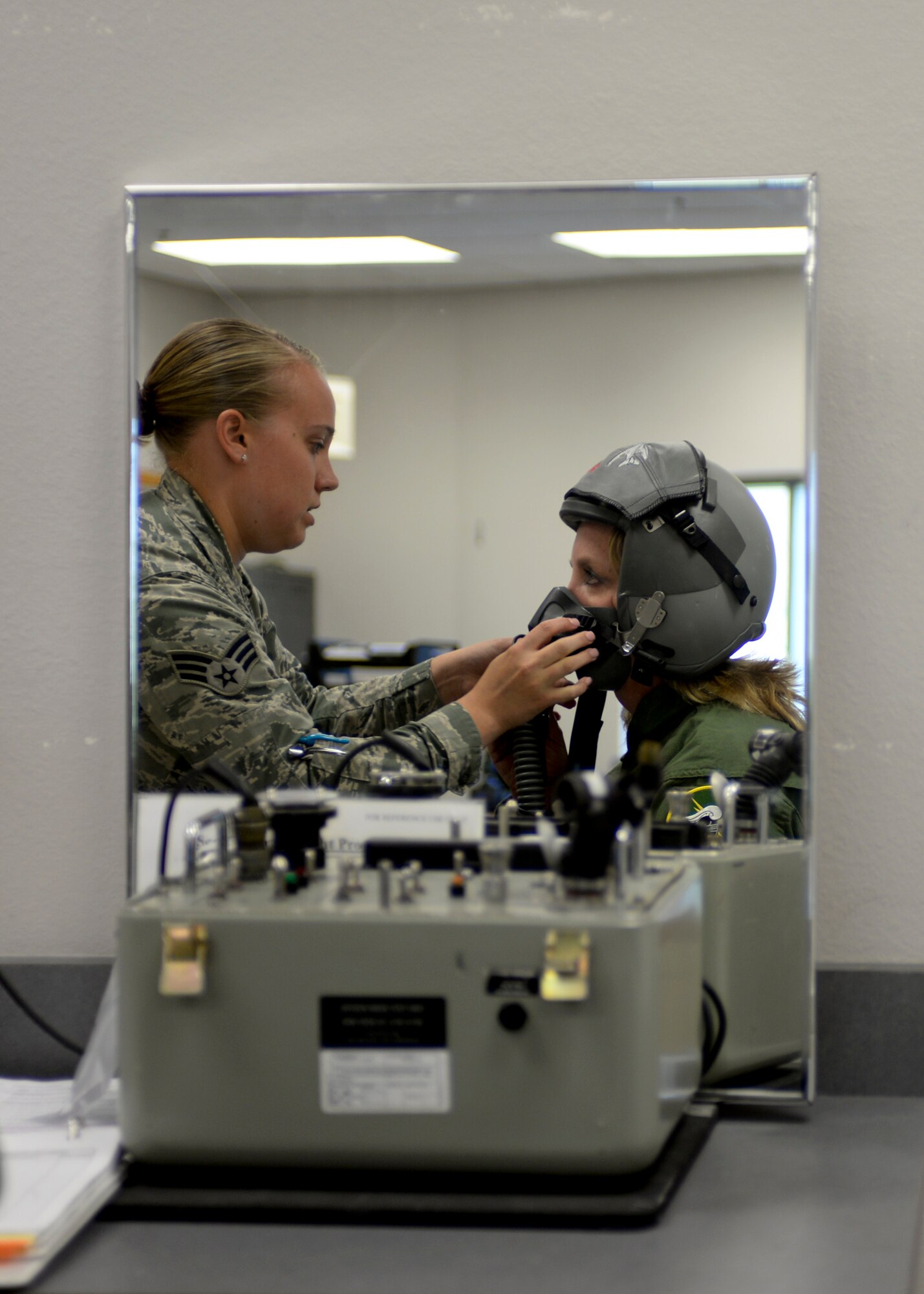Senior Airman Tess Bogner, 28th Operation Support Squadron aircrew flight equipment technician, adjusts a flight helmet on Secretary of the Air Force Deborah Lee James prior to a B-1 familiarization flight at Ellsworth Air Force Base, S.D., July 20, 2015. In addition to providing James with proper flight equipment, she was given a B-1 safety briefing, a requirement for aircrew prior to each B-1 flight. (U.S. Air Force photo by Senior Airman Anania Tekurio/Released)