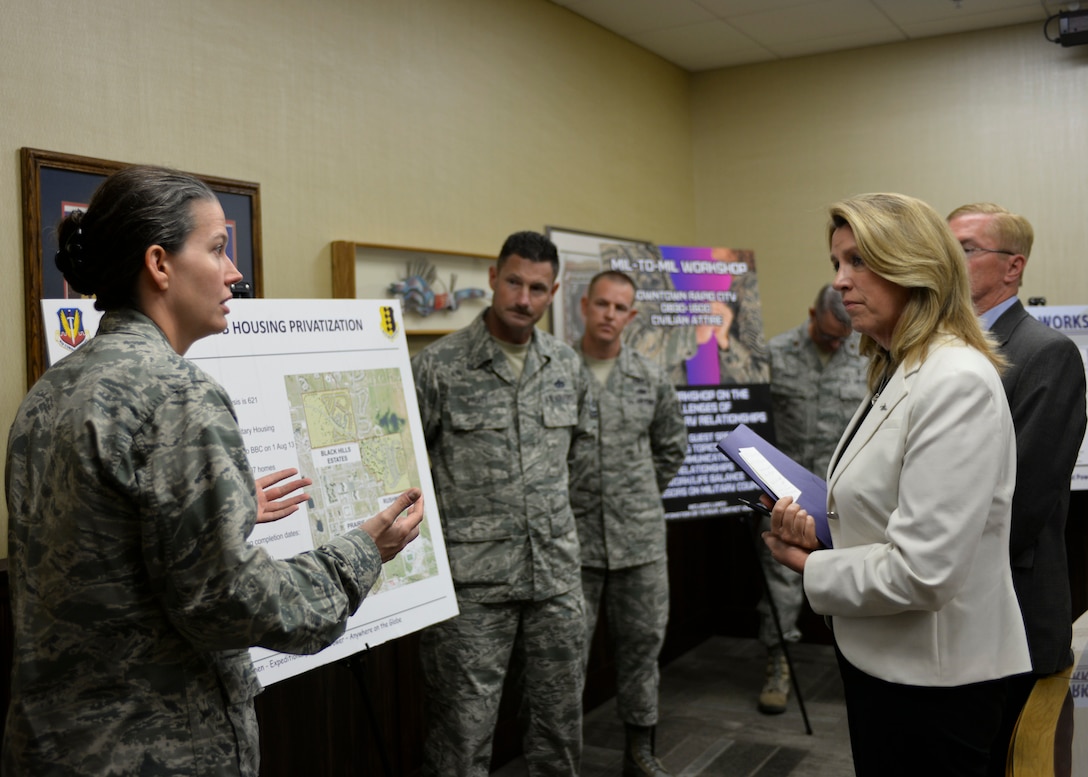 Lt. Col. Jennifer Phelps, 28th Civil Engineer Squadron commander, briefs Secretary of the Air Force Deborah Lee James about base housing construction at Ellsworth Air Force Base, S.D., July 20, 2015. Phelps provided insight about new base housing developments and how it offers base personnel more living options in a renter-saturated market. (U.S. Air Force photo by Senior Airman Anania Tekurio/Released)
