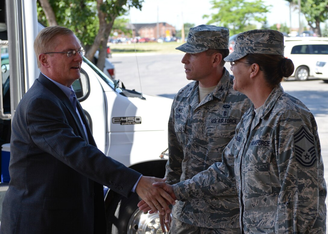 Chief Master Sgt. Tracey House, 28th Medical Group superintendent, greets Frank Beatty, spouse of Secretary of the Air Force Deborah Lee James, at Ellsworth Air Force Base, S.D., July 20, 2015. James, along with Beatty, visited several base facilities, getting to see Ellsworth’s Airmen in action. (U.S. Air Force photo by Senior Airman Anania Tekurio/Released)