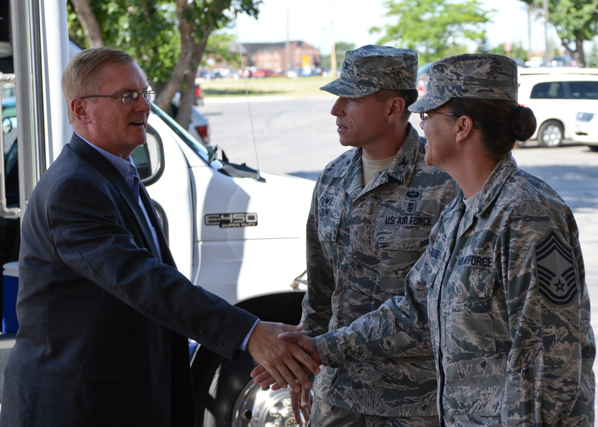 Chief Master Sgt. Tracey House, 28th Medical Group superintendent, greets Frank Beatty, spouse of Secretary of the Air Force Deborah Lee James, at Ellsworth Air Force Base, S.D., July 20, 2015. James, along with Beatty, visited several base facilities, getting to see Ellsworth’s Airmen in action. (U.S. Air Force photo by Senior Airman Anania Tekurio/Released)