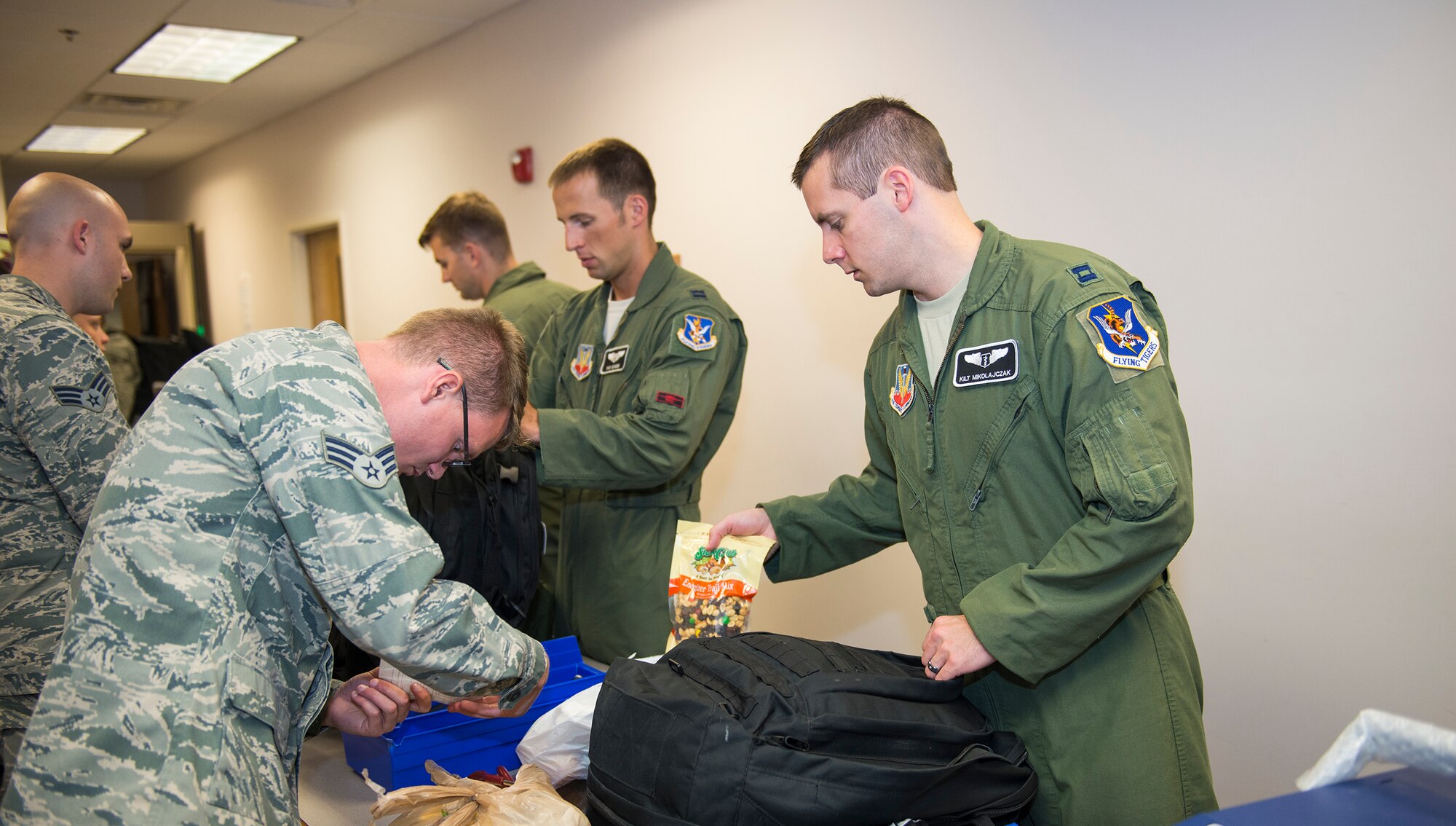 Pilots from the 75th Fighter Squadron process through an assembly line before leaving to Green-Flag West July 16, 2015, at Moody Air Force Base, Ga. All four military services, to include guard and reserve components, participate in the two week temporary duty assignment twice a year at Nellis AFB, Nev. (U.S. Air Force photo by Airman Greg Nash/Released)