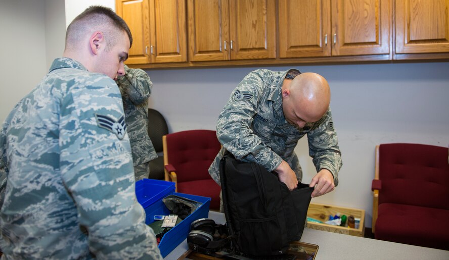 U.S. Air Force Senior Airman Marcus Strait, 23d Logistics Readiness Squadron petroleum, oils and fuels journeyman, checks an Airman’s bag for unauthorized items before leaving for Green Flag-West July 16, 2015, at Moody Air Force Base, Ga. Green Flag is an advanced air-to-surface training exercise which prepares joint and coalition warfighters for close air support missions to meet combatant commander objectives throughout air, space, and cyberspace at Nellis AFB, Nev. (U.S. Air Force photo by Airman Greg Nash/Released)