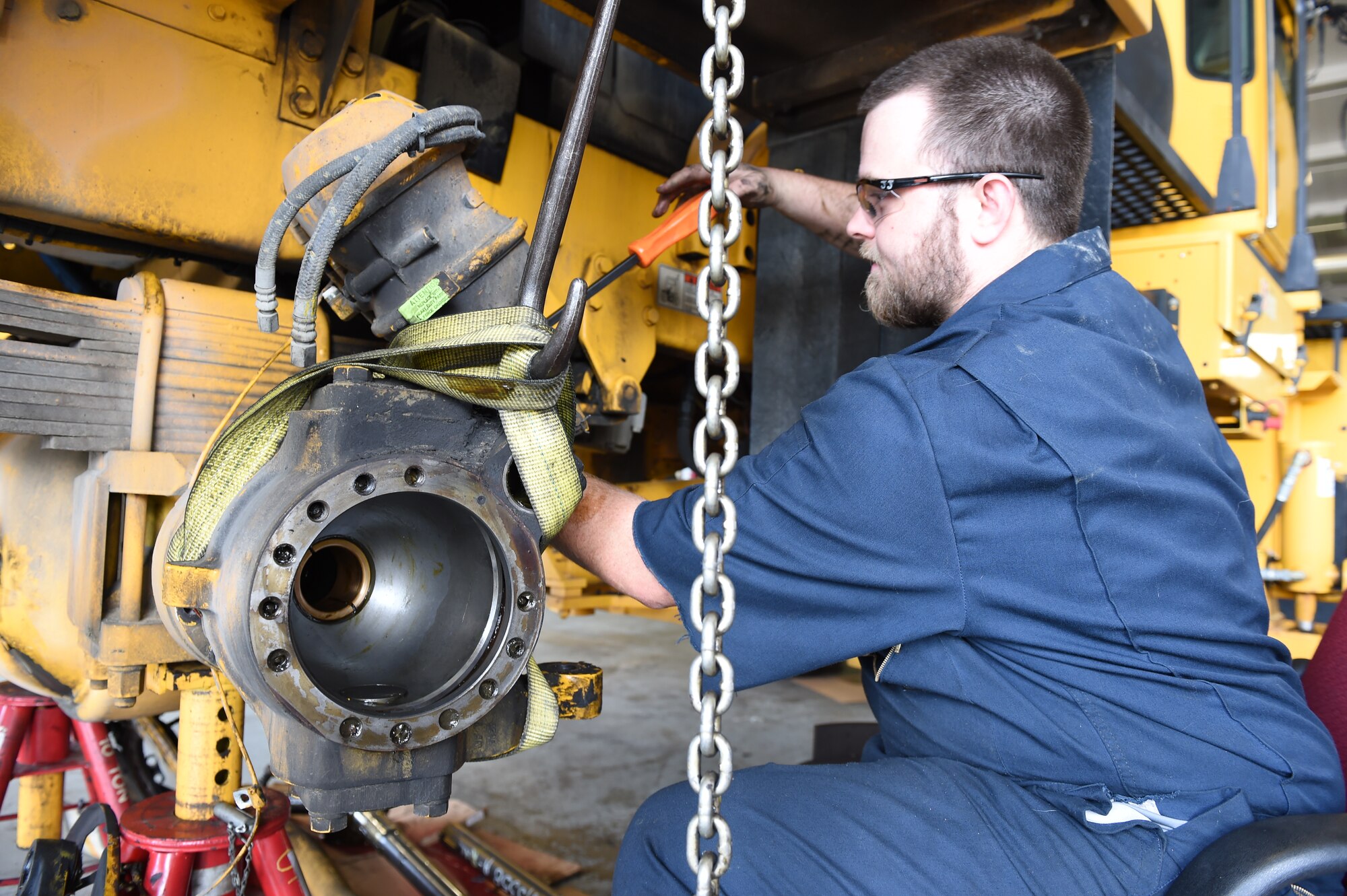 Mike Wagner, 11th Logistics Readiness Squadron heavy equipment mechanic, works on removing the knuckle of a snow plow vehicle as part of the snow fleet rebuild at Joint Base Andrews, Md., July 21, 2015. LRS Airmen ensure the snow fleet is ready for use before the winter season comes. (U.S. Air Force photo/Senior Airman Joshua R. M. Dewberry)