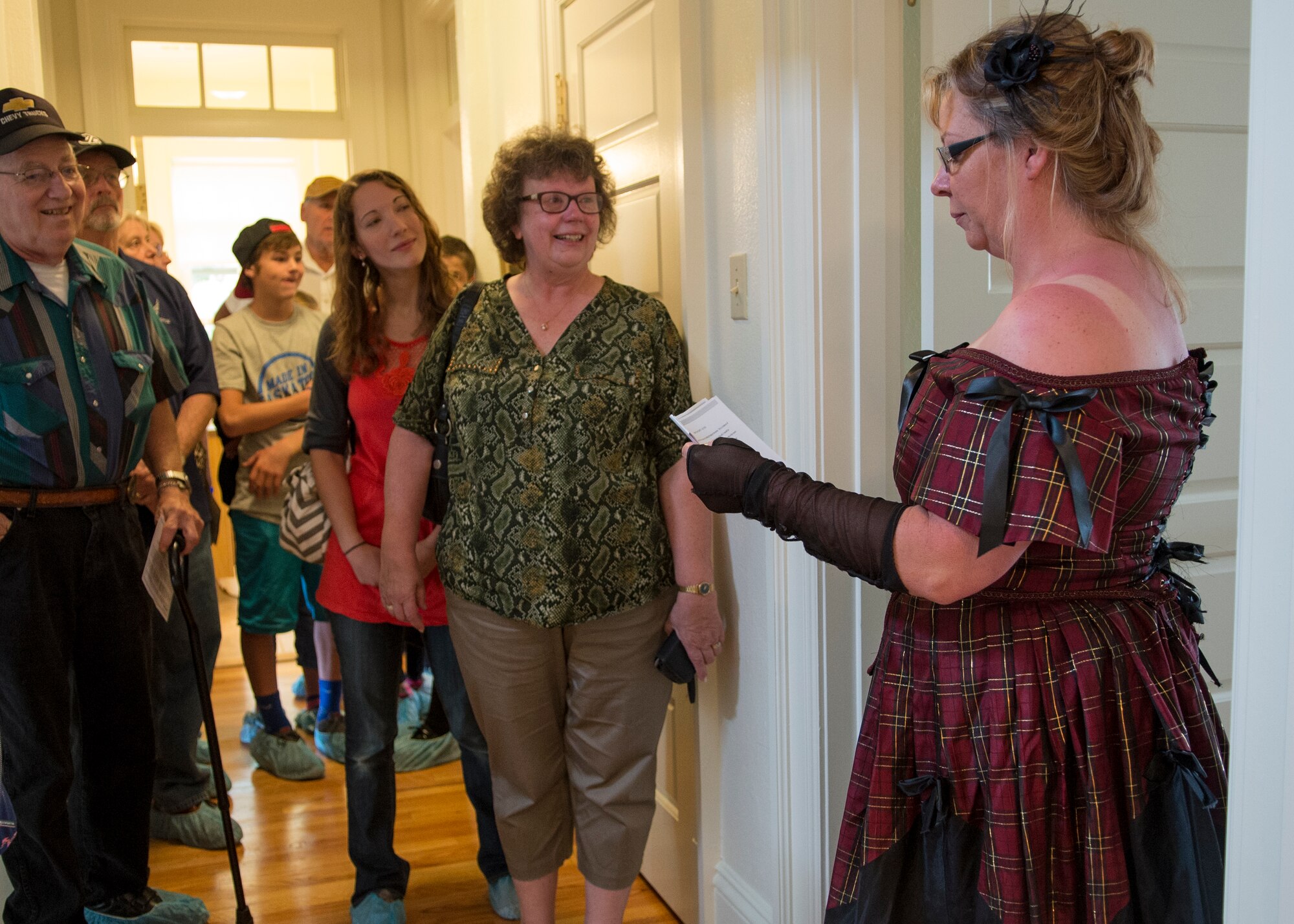 Danette Cochran, wife of Staff Sgt. Clifford Cochran, 321st Missile Squadron facility manager, guides visitors through quarters 120 during the Historic Homes Tour at Fort D.A. Russell Days, July 19, 2015, on F.E. Warren Air Force Base, Wyo. The tour takes guests through three separate homes built around the start of the 20th Century. (U.S. Air Force photo by Airman 1st Class Malcolm Mayfield)