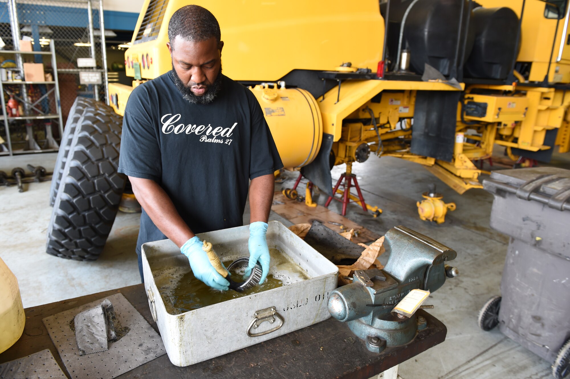 Terrence Upperman, 11th Logistics Readiness Squadron heavy equipment mechanic, cleans off the wheel bearings of a snow plow vehicle as part of the snow fleet rebuild at Joint Base Andrews, Md., July 21, 2015. LRS Airmen ensure the snow fleet is ready for use before the winter season comes. (U.S. Air Force photo/Senior Airman Joshua R. M. Dewberry)