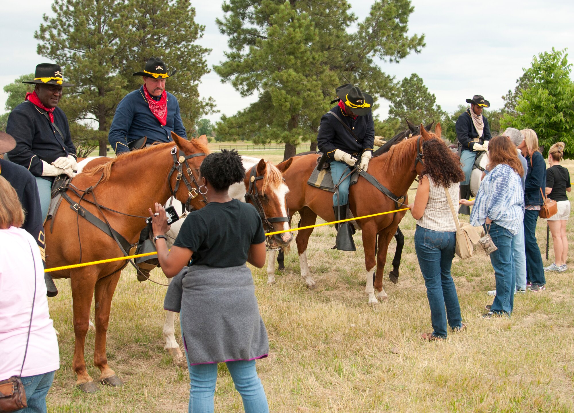 Buffalo Soldiers of the American West, a re-enactment group out of Brighton, Colo., answer spectator questions after their demonstration on F.E. Warren Air Force Base, Wyo., July 19, 2015, during Fort D.A. Russell Days, the base’s annual open house. This is the first time the group participated in Fort D.A. Russell Days. (U.S. Air Force photo by Senior Airman Jason Wiese)