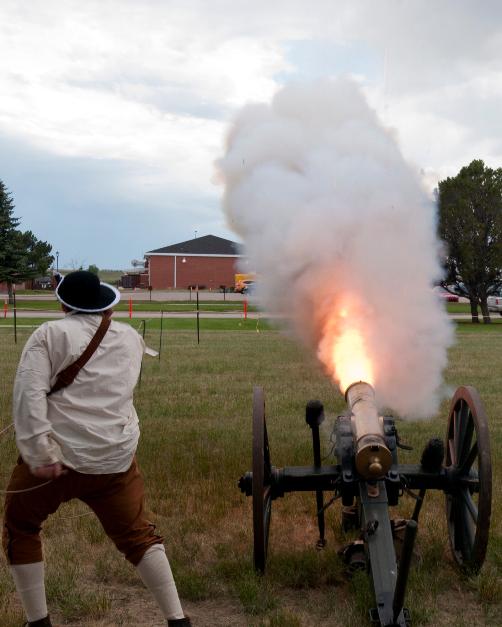 A historical re-enactor, pulls the firing pin on a cannon during a demonstration July 18, 2015, as part of the F.E. Warren Air Force Base, Wyo., open house, Fort D.A. Russell Days. (U.S. Air Force photo by Airman 1st Class Brandon Valle)