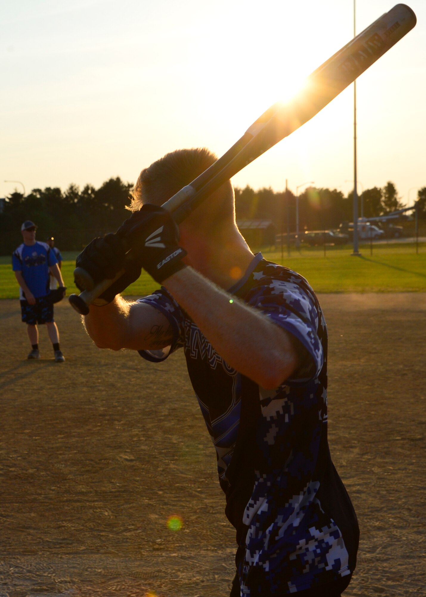Jordan Hucks, 436th Security Forces Squadron left fielder, takes warm up swings with multiple bats while in the on-deck circle during an intramural softball game against the 436th Maintenance Squadron July 20, 2015, at the softball field on Dover Air Force Base, Del. The 436th SFS defeated the 436th MXS, 11-10, putting them one step closer to making the playoffs. (U.S. Air Force photo/Airman 1st Class William Johnson)