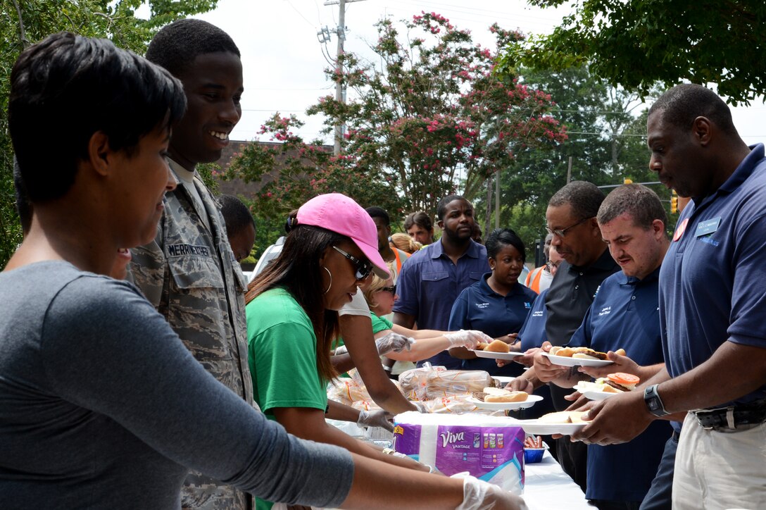 AbilityOne employees receive food during the AbilityOne Employee Appreciation Picnic held at Memorial Lake at Shaw Air Force Base, S.C., July 17, 2015. Team Shaw members volunteered their time to serve and thank the employees for their hard work throughout the year. (U.S. Air Force photo by Senior Airman Jonathan Bass/Released)