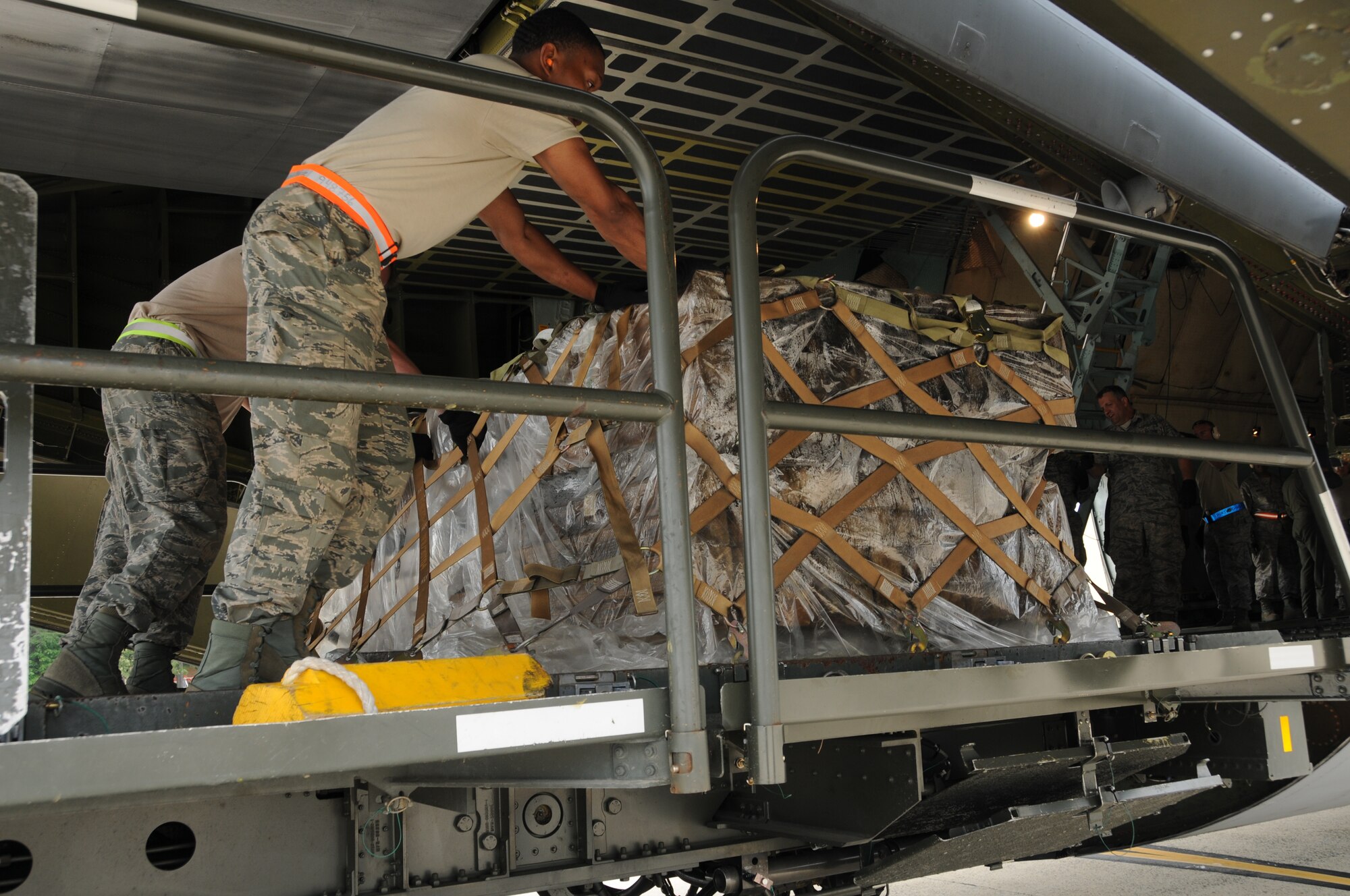 Airmen from the 69th Aerial Port Squadron loaded a C-5 aircraft from the 433 Airlift Wing from San Antonio, Texas.  The scenario entailed training real-world purposes.  This rare event occurred on June 7, 2015. (US Air Force Photo / Maj. Tim Smith)