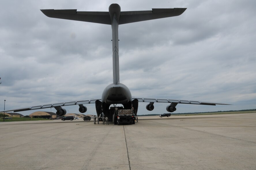 Airmen from the 69th Aerial Port Squadron loaded a C-5 aircraft from the 433 Airlift Wing from San Antonio, Texas.  The scenario entailed training real-world purposes.  This rare event occurred on June 7, 2015. (US Air Force Photo / Maj. Tim Smith)