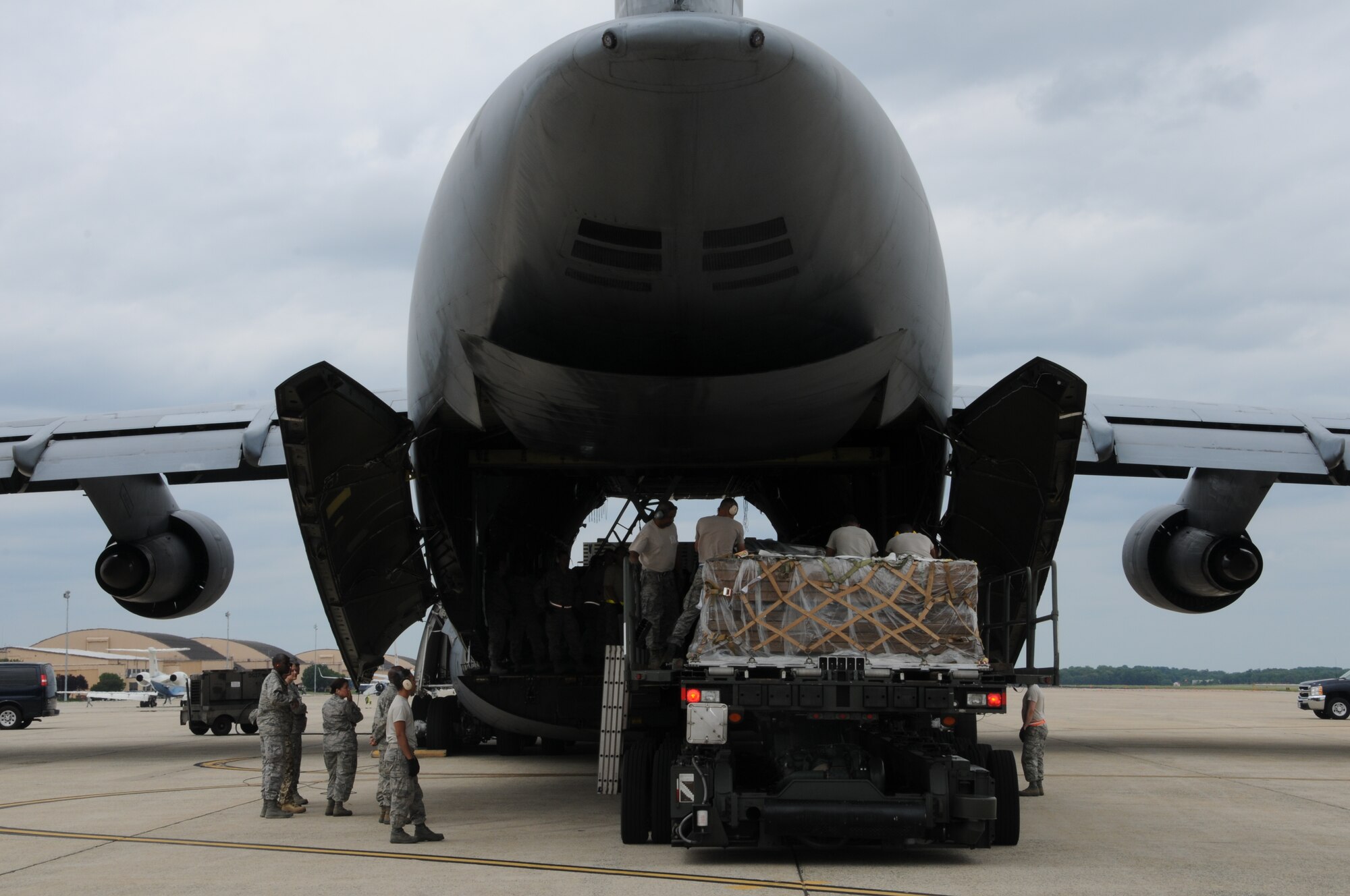 Airmen from the 69th Aerial Port Squadron loaded a C-5 aircraft from the 433 Airlift Wing from San Antonio, Texas.  The scenario entailed training real-world purposes.  This rare event occurred on June 7, 2015. (US Air Force Photo / Maj. Tim Smith)