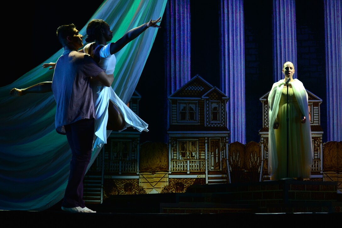 U.S. Army Spc. Elise Baldwin, U.S. Army Morale, Welfare and Recreation Programs Soldier Show performer, sings opera during performance at Fort Eustis, Va., July 15, 2015.  As Baldwin sang, U.S. Army MWR program Soldier Show Dancers Sgt. Andrew Enriquez, left, and Specialist Dozje Brown danced ballet.  (U.S. Air Force photo by Staff Sgt. Natasha Stannard/Released)