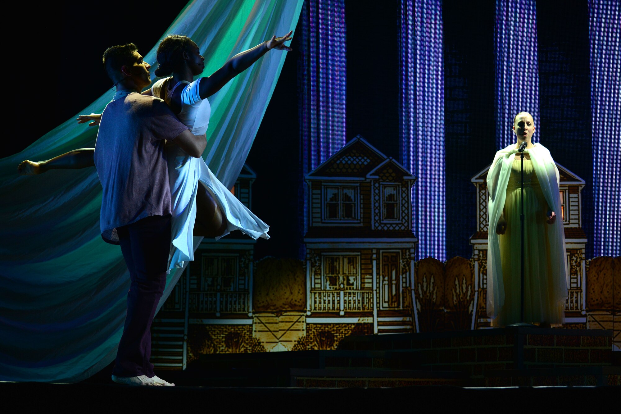U.S. Army Spc. Elise Baldwin, U.S. Army Morale, Welfare and Recreation Programs Soldier Show performer, sings opera during performance at Fort Eustis, Va., July 15, 2015.  As Baldwin sang, U.S. Army MWR program Soldier Show Dancers Sgt. Andrew Enriquez, left, and Specialist Dozje Brown danced ballet.  (U.S. Air Force photo by Staff Sgt. Natasha Stannard/Released)