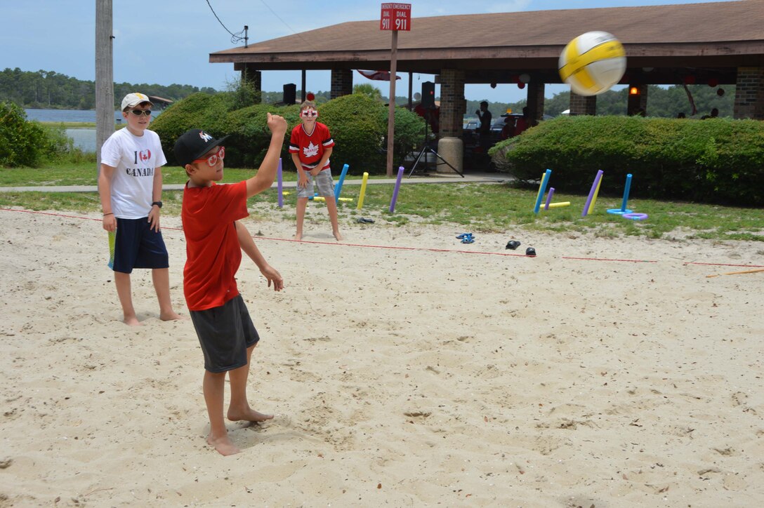 Outfitted in celebratory Canada Day attire, some young guests enjoy the July 1 celebration at Bonita Bay with some volleyball. Members of the Canadian Detachment assigned to Headquarters Continental U.S. North American Aerospace Defense Region – 1st Air Force (Air Forces Northern) celebrated the 148th observation of Canada’s independence from the British Empire by hosting an afternoon of food and games. (Air Force Photo Released/Mary McHale)