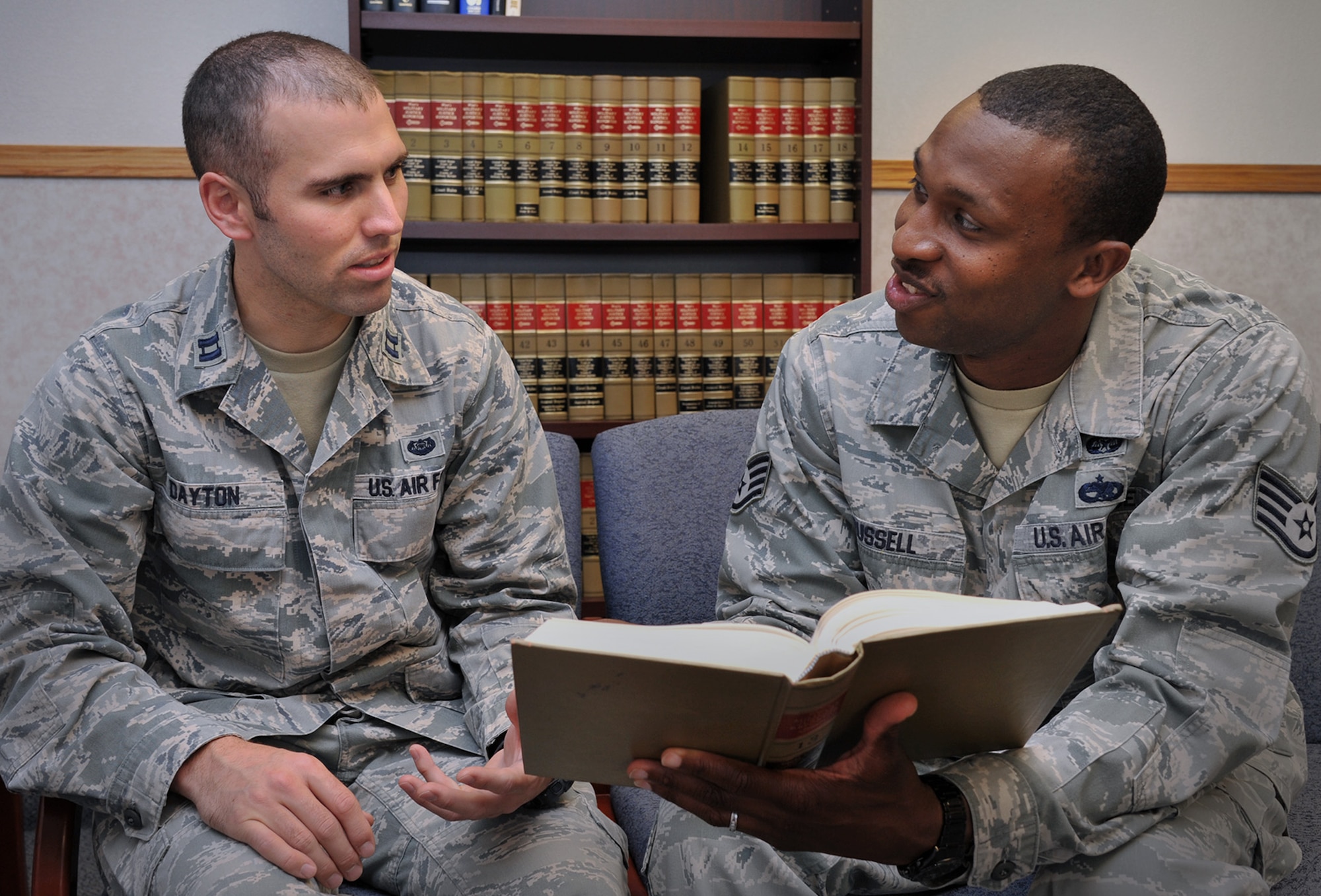 Capt. David Dayton, defense attorney, left, and Staff Sgt. Donte Russell, defense paralegal, review military law July 20, 2015. As Malmstrom Air Force Base’s Area Defense Counsel, the two work together to represent Airmen who are facing adverse actions in administrative or military proceedings. (U.S. Air Force photo/John Turner)