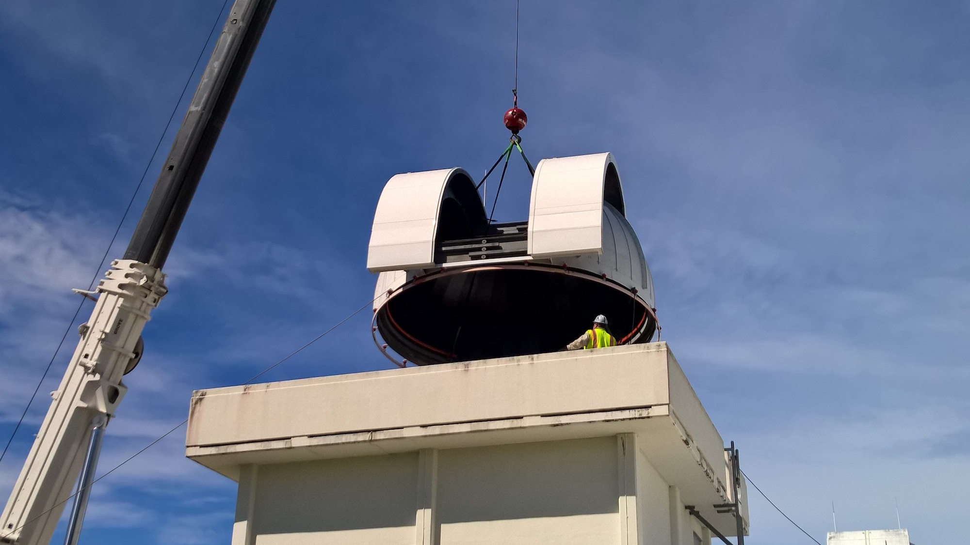 BRITISH INDIAN OCEAN TERRITORIES -- Workers replace a dome on a telescope at Detachment 2, 21st Operations Group, a geographically separated unit of the 21st Space Wing located on Diego Garcia Naval Support Facility in the British Indian Ocean Territories. The low level of light pollution in the remote ocean location allows the telescopes a clearer view of space. (U.S. Air Force photo)