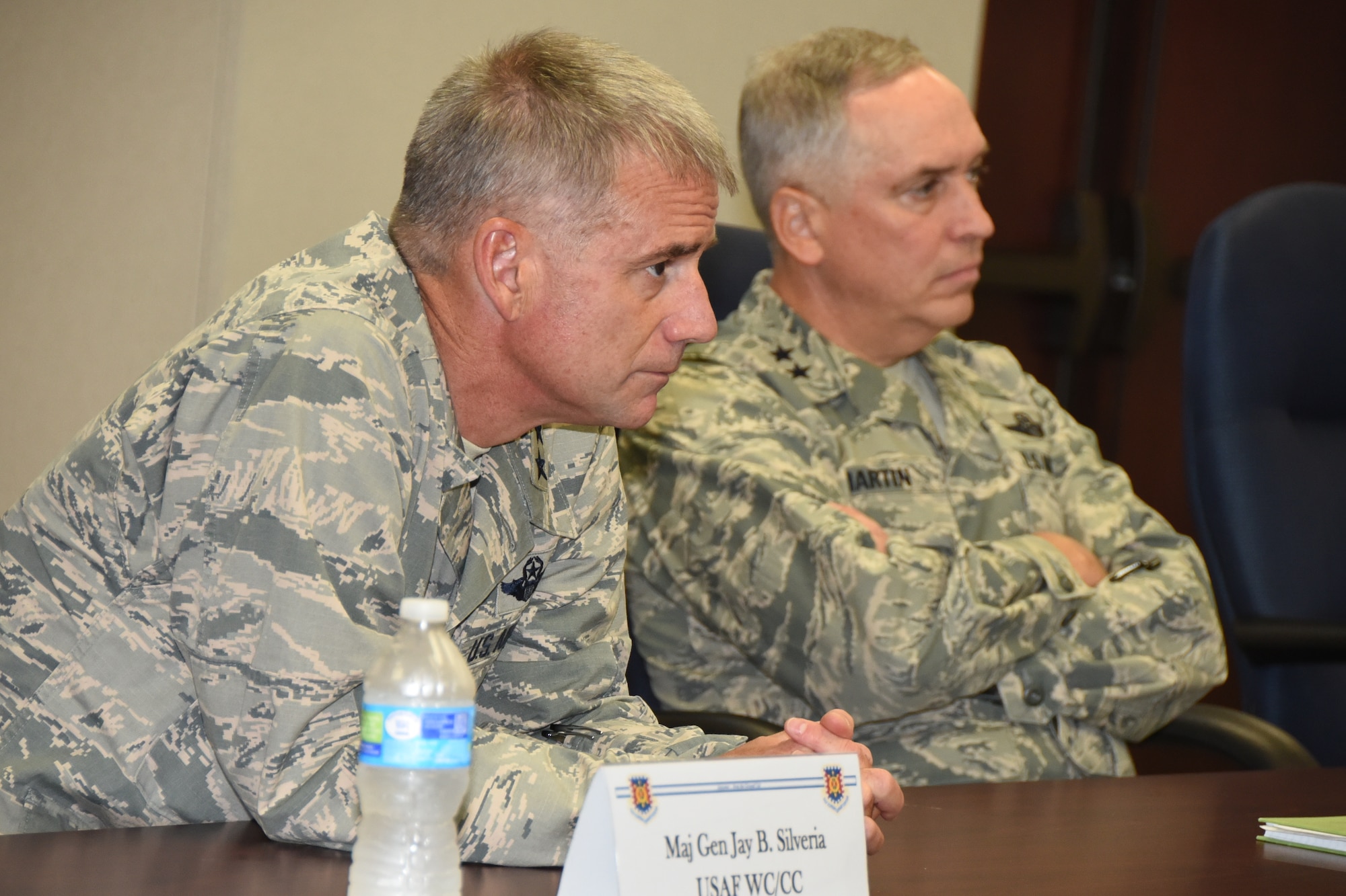 Maj. Gen. Jay Silveria, U.S. Air Force Warfare Center commander, sits with Maj. Gen. Rick Martin, U.S. Air Force Expeditionary Center commander, during a briefing at Joint Base McGuire-Dix-Lakehurst, N.J., July 15, 2015. General Silveria visited the base to learn more about the USAF EC mission and discuss opportunities where the two centers can work together in the future. (U.S. Air Force photo by Brad Camara)