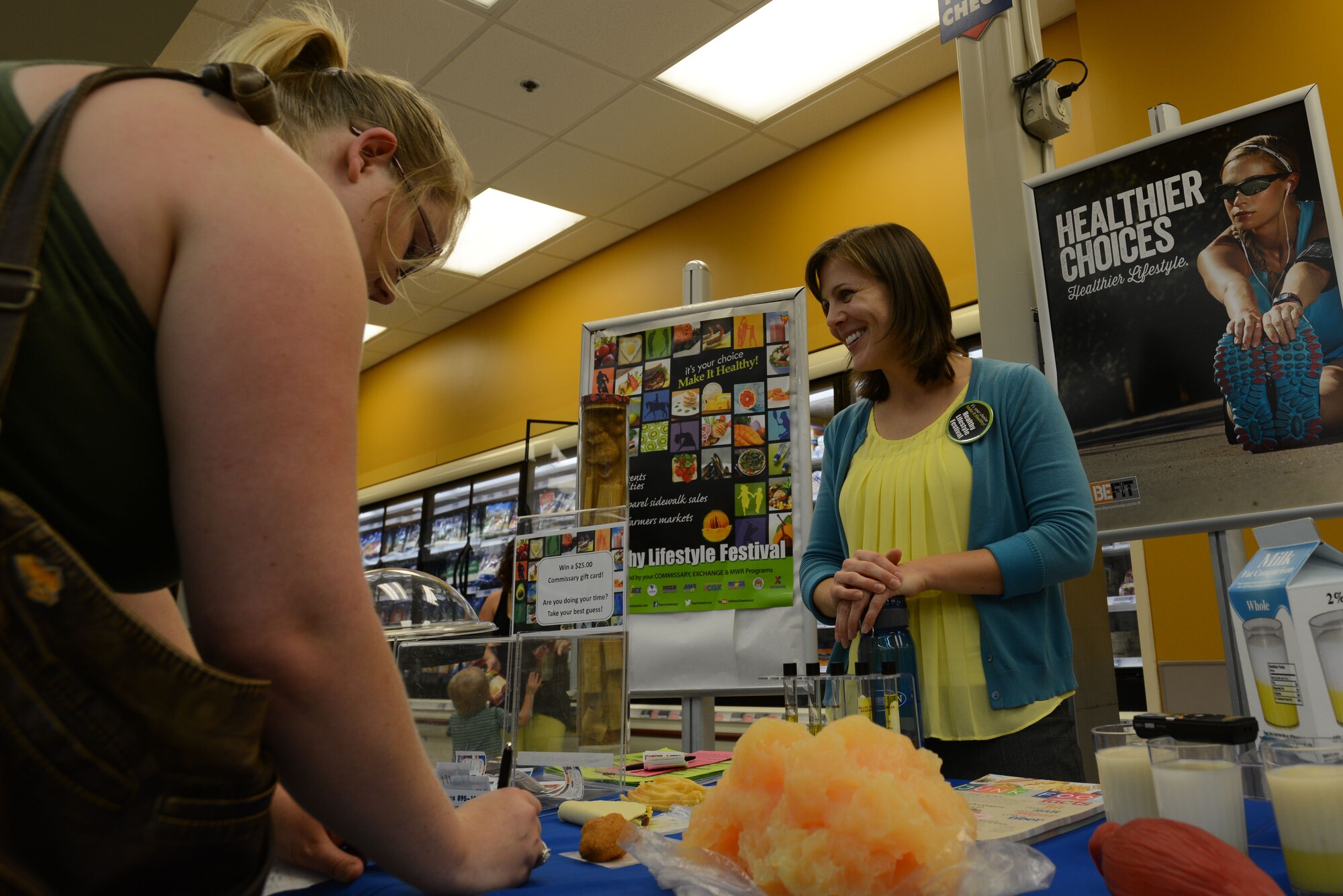 Janine Reinholtz, 20th Aerospace Medicine Squadron Health Promotions registered dietitian, speaks with visitors during the Healthy Lifestyle Festival inside the Commissary at Shaw Air Force Base, S.C., July 16, 2015. The festival theme for this year was ‘Shop Healthy! Eat Healthy! Be Healthy!’. (U.S. Air Force photo by Airman 1st Class Kelsey Tucker/Released)