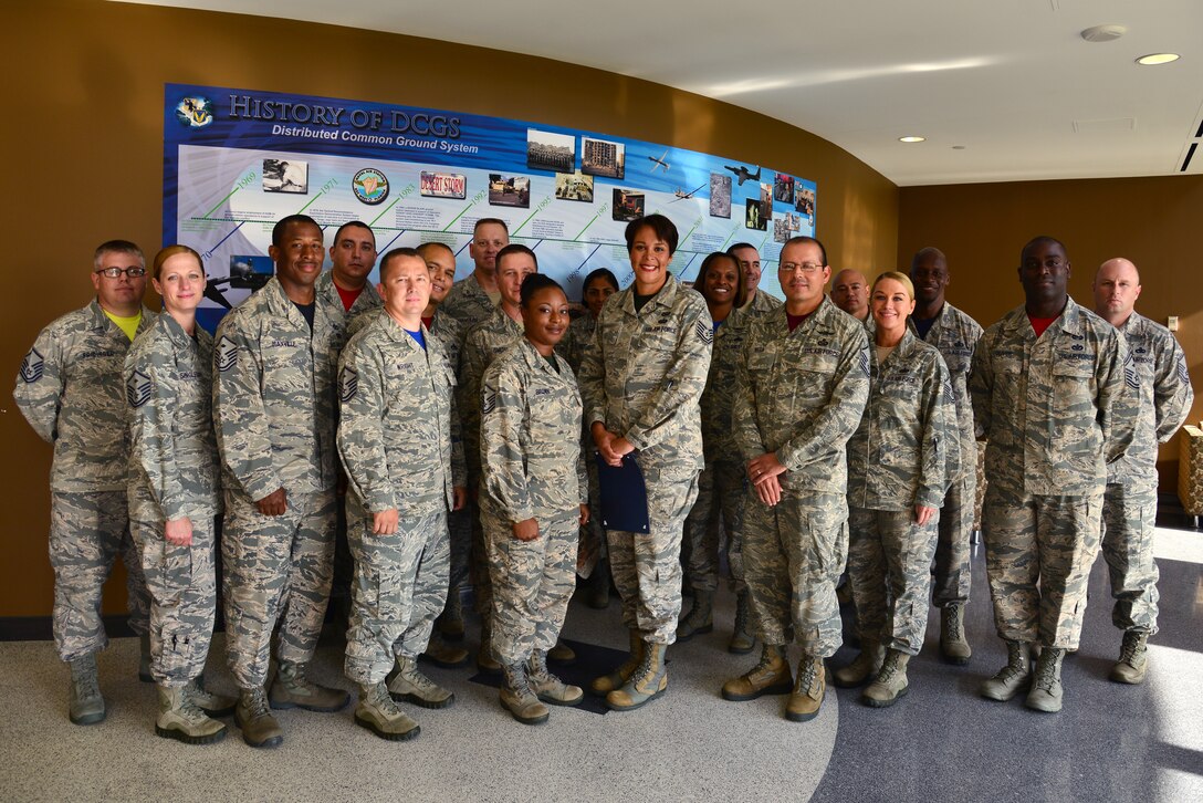 U.S. Air Force first sergeants commend Tech. Sgt. Angie Handy, 440th Supply Chain Operations Squadron equipment and allowance authorization fighter cell lead, for receiving a Diamond Sharp award at Langley Air Force Base, Va., July 17, 2015. Handy brought the challenges of being a single mom working various 12-hour shifts and finding childcare to the attention of her superiors, warranting new childcare services for personnel in similar positions. (U.S. Air Force photo by Senior Airman Aubrey White/Released)