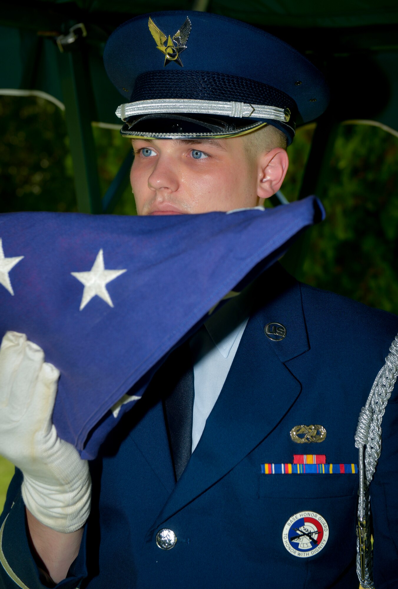 Airman 1st Class Joseph Meskimen, Barksdale Honor Guard, inspects the flag during the final dress rehearsal for a funeral in Bossier City, La., July 27, 2015. Meskimen inspects the flag for any imperfections before presenting the flag to the next of kin. (U.S. Air Force photo/Airman 1st Class Mozer O. Da Cunha