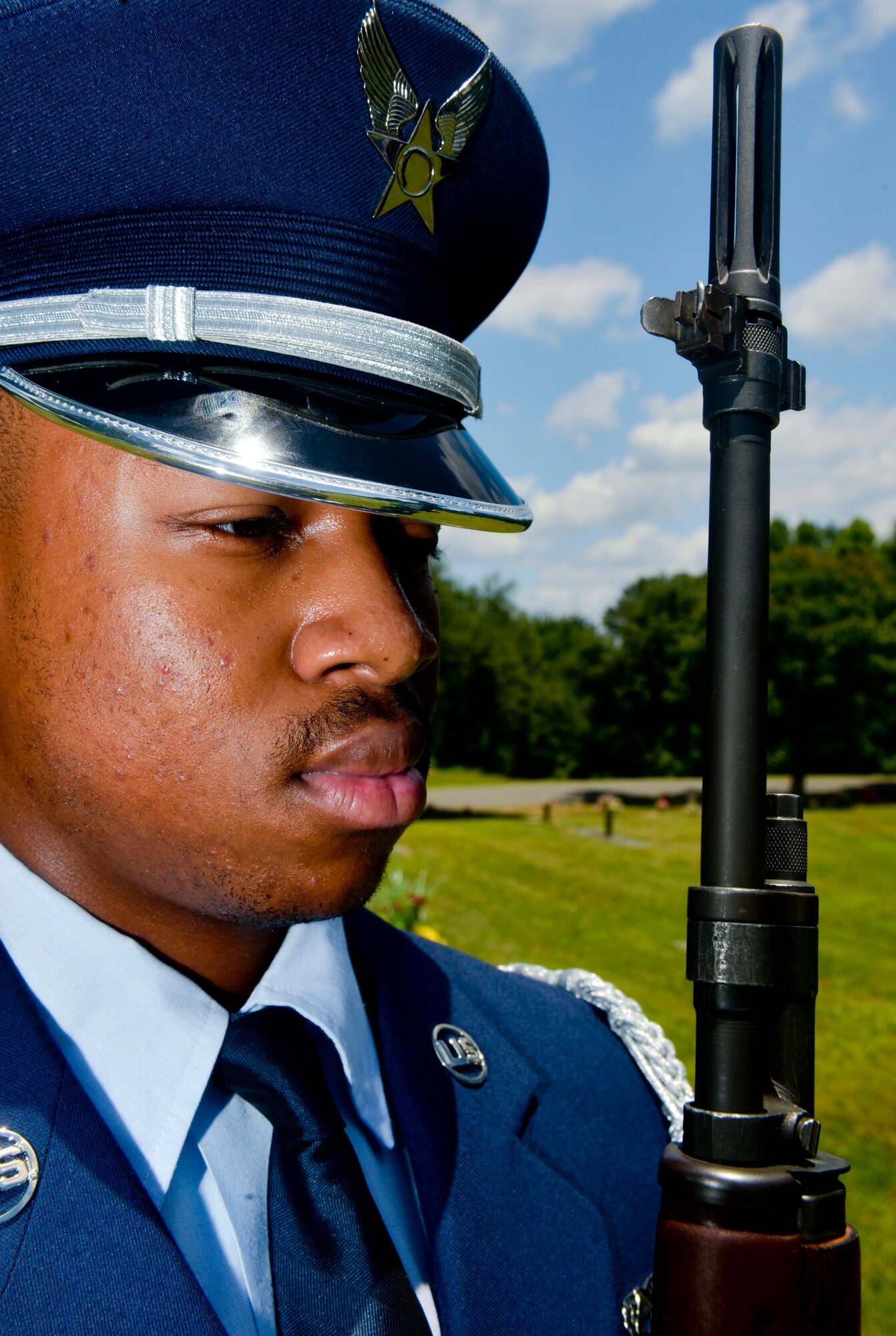 Airman 1st Class Clement O’Neal, Barksdale Honor Guard, waits for a command during a firing ceremony at a funeral in Bossier City, La., July 27, 2015. O’Neal demonstrates the highest level of professionalism and discipline by executing a series of movements in unison with his teammates. (U.S. Air Force photo/Airman 1st Class Mozer O. Da Cunha)