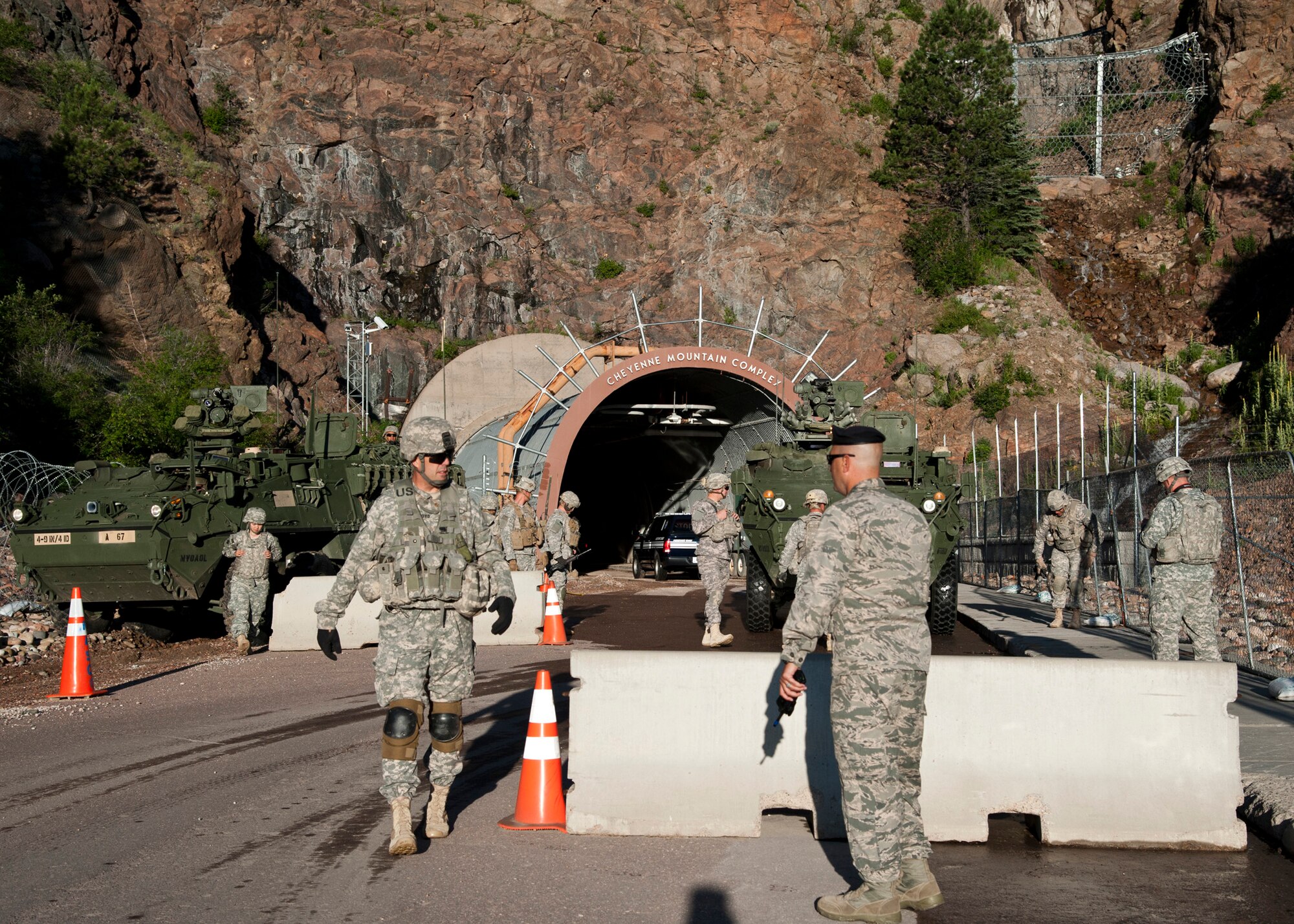 CHEYENNE MOUNTAIN AIR FORCE STATION, Colo. – U.S. Army Maj. Kevin Boyd, 4th Infantry Division, 1st Stryker Brigade Combat Team public affairs officer, coordinates exercise response with Maj. Kevin Lombardo, 721st Security Forces Squadron commander, upon arrival to the main portal at Cheyenne Mountain Air Force Station, July 15, 2015. The blocking force exercise tested the ability of Fort Carson and CMAFS to execute a joint mission, manage resources, stewardship of manpower and equipment readiness as part of existing support agreements. (U.S. Air Force photo by Senior Airman Tiffany DeNault)