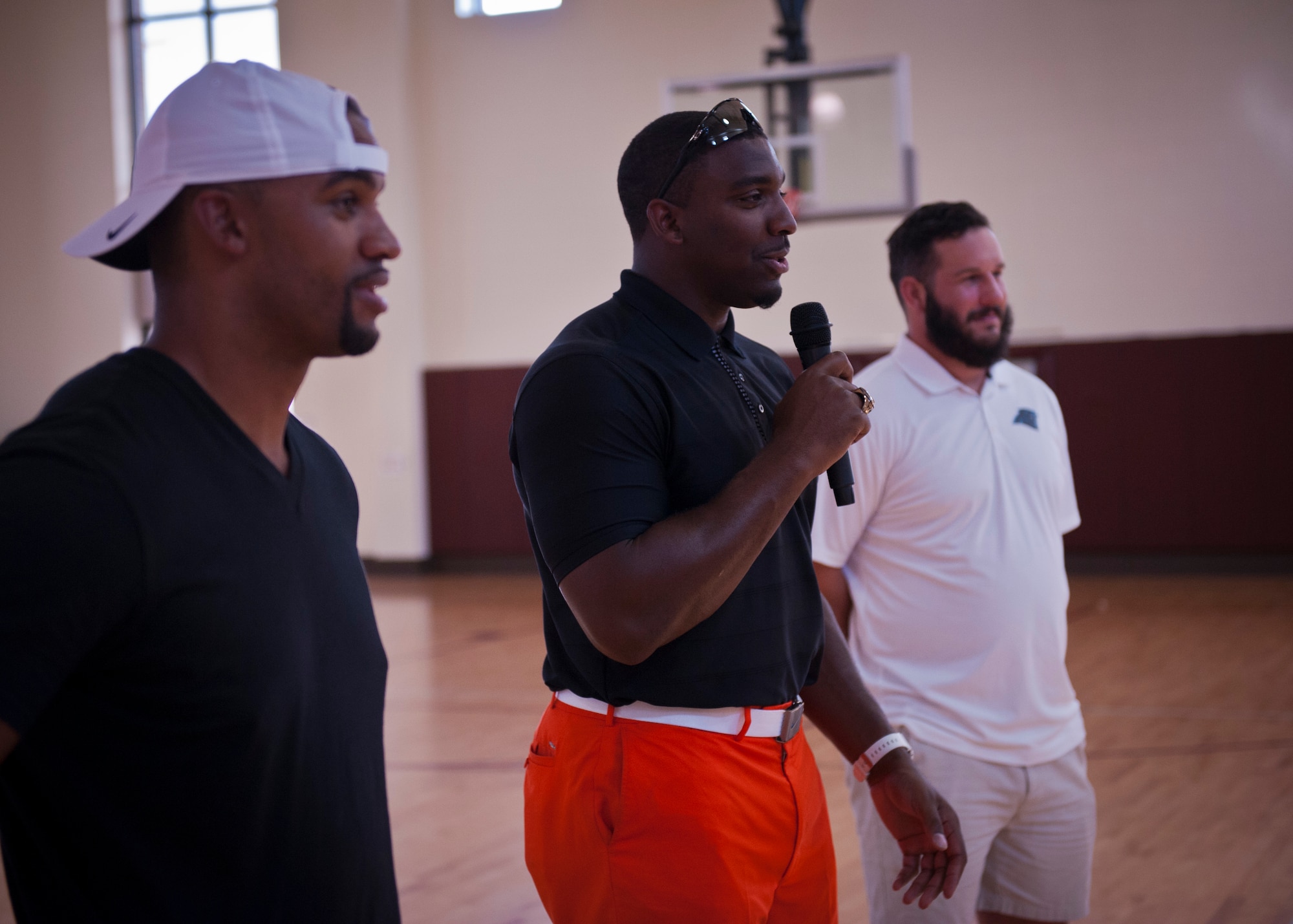 PETERSON AIR FORCE BASE, Colo. – Greg Scruggs (center), defensive end for the Seattle Seahawks, gives advice about sports and life to Peterson youth at the R.P. Lee Youth Center, July 13, 2015. Scruggs, Anthony Trucks (left), former linebacker for the Pittsburgh Steelers, and Brian Folkerts (right), Carolina Panthers center, were at Peterson for the Pro Football Camp, a nonprofit organization that uses football to give back to the community and encourage youth. (U.S. Air Force photo by Airman 1st Class Rose Gudex)