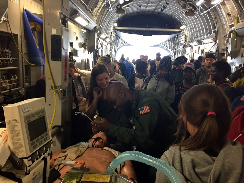 DAYTON, Ohio – 445th Aeromedical Staging Squadron’s Critical Care Air Transport Team Airman Staff Sgt. Samuel Collier, respiratory therapist, answer questions and demonstrates various equipment used by his team during a demonstration at the Vectren Dayton Air Show June 20, 2015. More than 40,000 attendees of the 41st Annual Vectren Dayton Air Show June 20 to 21, 2015 had the opportunity to visit with five 445th Airlift Wing Airmen assigned to the 445th ASTS CCATT. The Airmen set up a static display onboard a 445th AW C-17 Globemaster III. Air show attendees were allowed to interact with the Airmen and learn about the various equipment the team uses on a day-to-day basis plus understand the role of those assigned to the CCATT. (U.S. Air Force photo/Lt. Col. Laura Wiggins)