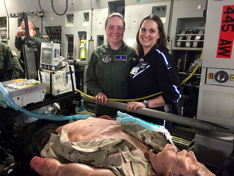 DAYTON, Ohio – 445th Aeromedical Staging Squadron’s Critical Care Air Transport Team reservist Lt. Col. Laura Wiggins, critical care nurse, CRNA, talks to Angela Sebald, Care Flight registered nurse (CCATT civilian counterpart) about their role in the air and the equipment they use. Sebald and her team respond via helicopter to major accident scenes or other civilian casualty situation in the Dayton/Cincinnati area. More than 40,000 attendees of the 41st Annual Vectren Dayton Air Show June 20 to 21, 2015 had the opportunity to visit with five 445th Airlift Wing Airmen assigned to the 445th ASTS CCATT. The Airmen set up a static display onboard a 445th AW C-17 Globemaster III. Air show attendees were allowed to interact with the Airmen and learn about the various equipment the team uses on a day-to-day basis plus understand the role of those assigned to the CCATT. (U.S. Air Force photo/Lt. Col. Laura Wiggins)
