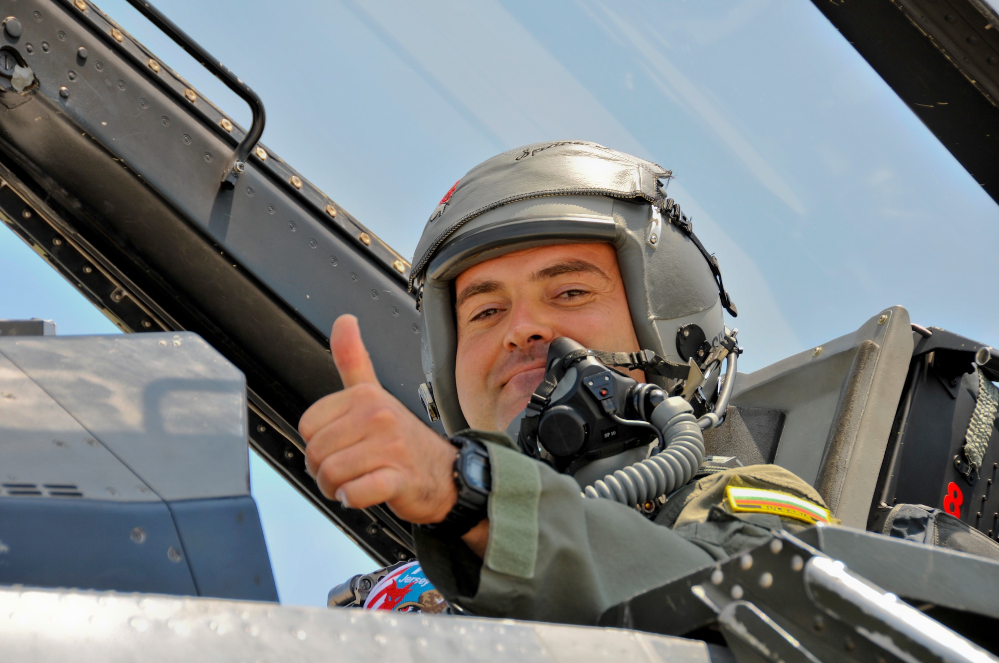 A picture of Capt. Ivan Dinkov, a Bulgarian air force MiG-29 pilot, giving a thumbs up from the cockpit of a U.S. Air Force F-16D Fighting Falcon.