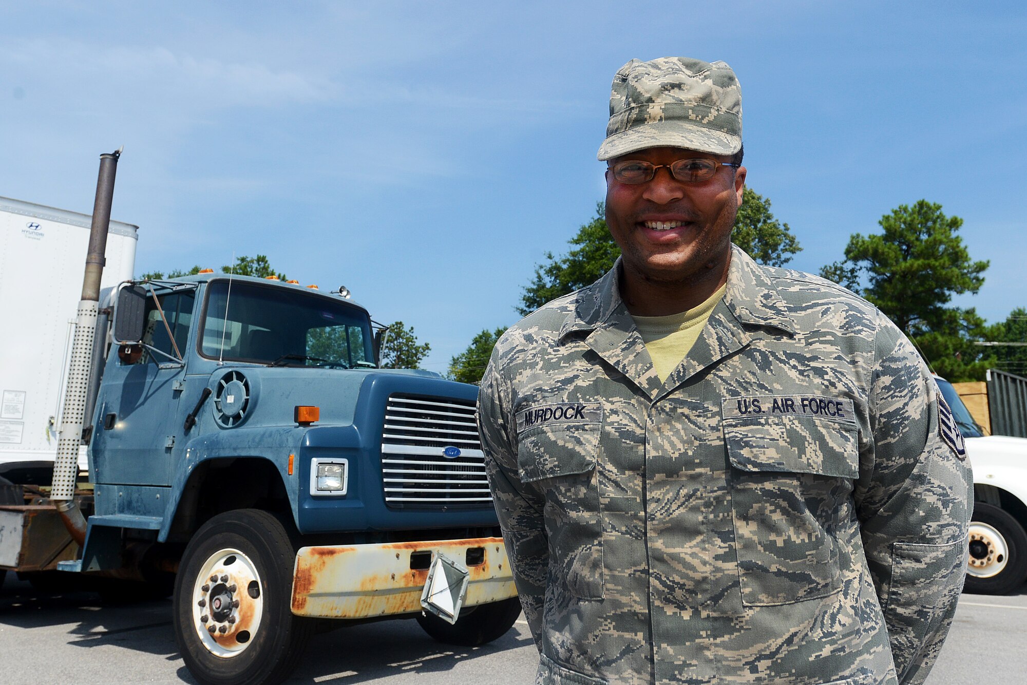 U.S. Air Force Staff Sgt. Scott Murdock, 20th Logistics Readiness Squadron Vehicle Operations Control Center supervisor, stands in front of the trucks he manages logistics for at Shaw Air Force Base, S.C., July 20, 2015. Murdock was diagnosed with soft tissue sarcoma in 2014 after returning from a six month deployment to Afghanistan and battled the cancer for approximately a year-and-a-half until he was cancer free. (U.S. Air Force photo by Senior Airman Diana M. Cossaboom/Released)