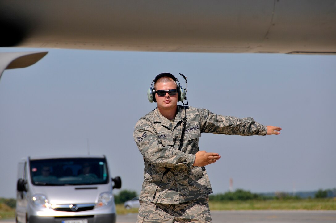 U.S. Air Force Senior Airman Keith Bates, crew chief with the 177th Fighter Wing of the New Jersey Air National Guard, marshals an F-16C Fighting Falcon prior to takeoff at Graf Ignatievo Air Base, Bulgaria, on July 13, 2015. The 177th FW is participating in Thracian Star, a bilateral training exercise to enhance interoperability with the Bulgarian air force and to bolster readiness to conduct combined air operations. (U.S. Air National Guard photo by Master Sgt. Andrew J. Moseley/Released)