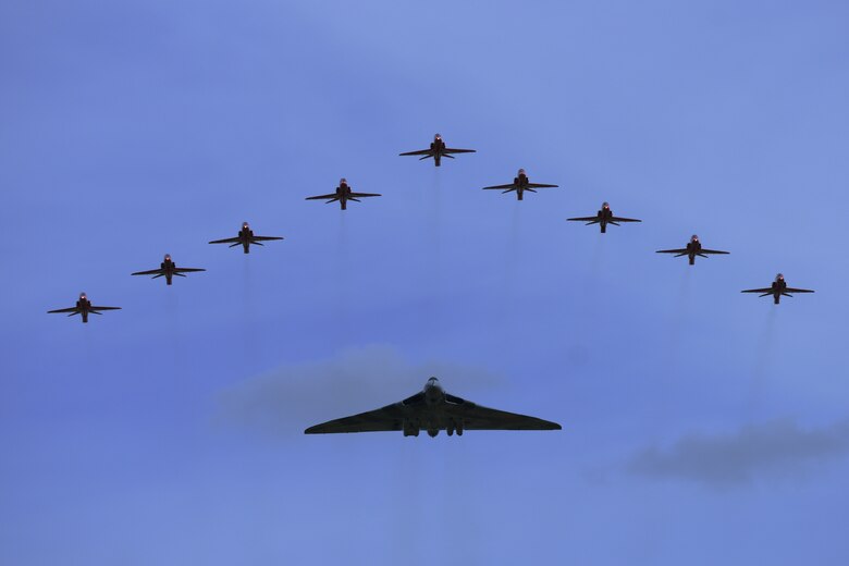 An Auro Vulcan B2 XH558, flies in formation with the Royal Air Force Red Arrows during the Royal International Air Tattoo in RAF Fairford, United Kingdom, July 18, 2015. This Vulcan has flown more hours than any others of its type.  (U.S. Air Force photo by Tech. Sgt. Chrissy Best/Released)