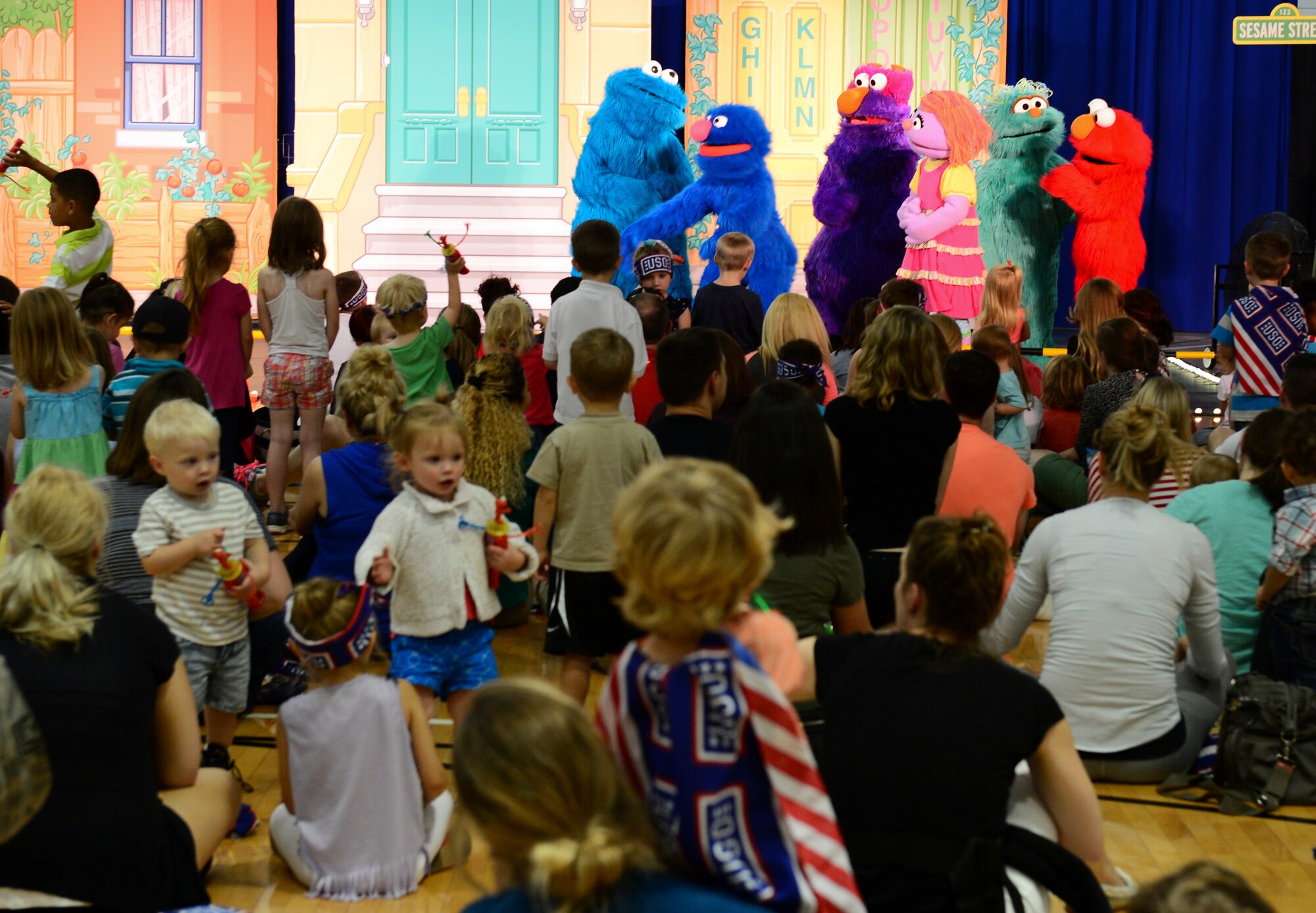 Elmo and friends perform on stage during a Sesame Street/USO Experience at Royal Air Force Lakenheath, England, July 20, 2015. The Sesame Street/USO Experience for Military Families is the USO’s longest-running, free-traveling tour based on Sesame Street's Military Family Initiative. (U.S. Air Force photo by Senior Airman Dawn M. Weber/Released)