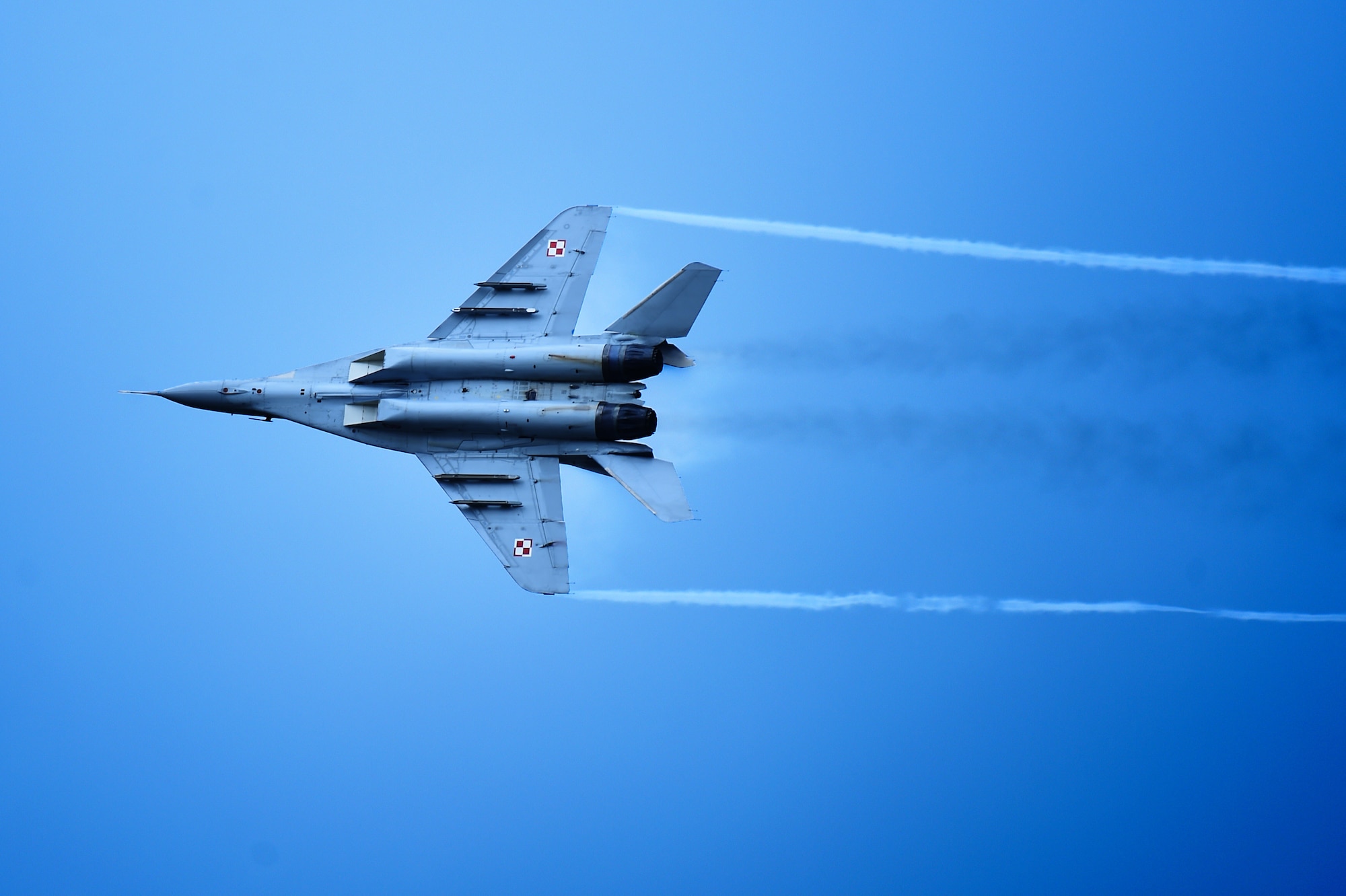 A Polish Air Force MiG-29 “Fulcrum,” from the 23rd Tactical Air Base at Mińsk Mazowiecki in eastern Poland, flies in the sky above RAF Fairford, United Kingdom, during the Royal International Air Tattoo, July 17, 2015. First held at North Weald Airfield, United Kingdom, in 1971, RIAT has since grown into the largest military airshow in the world. (U.S. Air Force photo by Staff Sgt. Jarad A. Denton/Released)