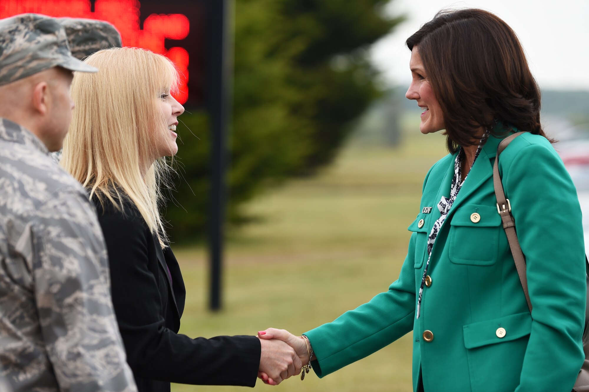 Michelle Mellars, wife of Col. Douglas Mellars, 422nd Air Base Group commander, left, greets Betty Welsh, wife of U.S. Air Force Chief of Staff, Gen. Mark A. Welsh III, at RAF Croughton, United Kingdom, July 16, 2015. Welsh visited the installation and spoke with military spouses on the ever-growing key spouse program. (U.S. Air Force photo by Staff Sgt. Jarad A. Denton/Released)