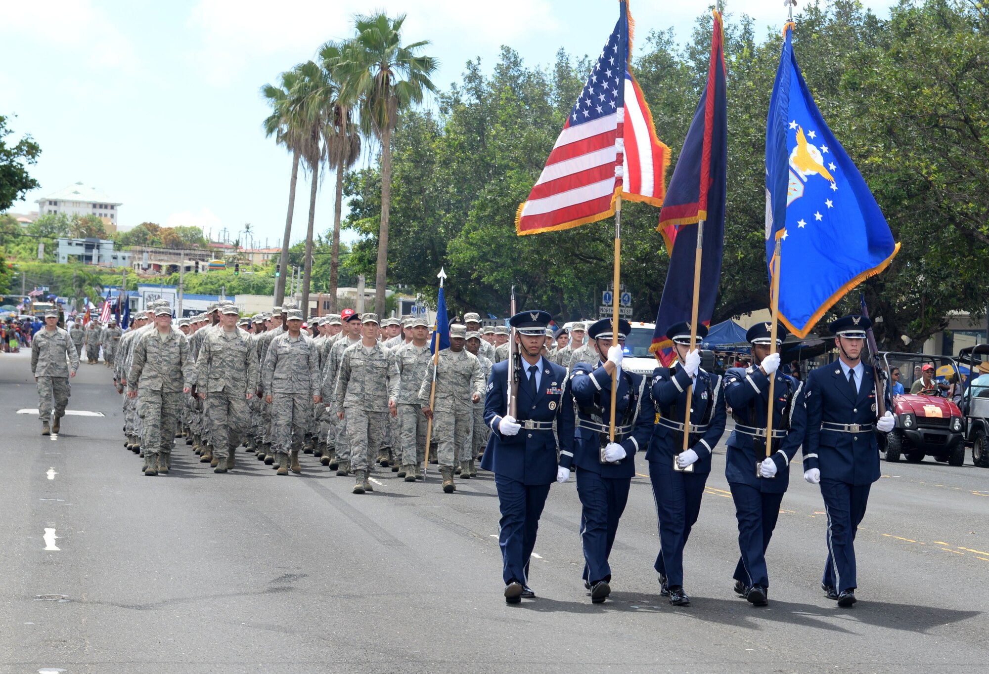 Five Andersen Blue Knights Honor Guard members lead a formation in the Liberation Day Parade July 21, 2015, in Hagåtña, Guam. Formations of active-duty service members, guardsmen and reservists, including more than 140 Airmen from the 36th Wing, marched in the parade down the 1.2-mile route past thousands of spectators. (U.S. Air Force photo by Senior Airman Joshua Smoot/Released)