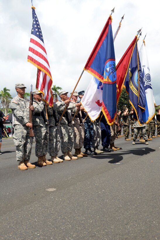 A joint service color guard presents the colors during the Liberation Day Parade July 21, 2015, in Hagåtña, Guam. The parade commemorated United States freeing the island from imperial Japan’s control during the Second Battle of Guam, which began July 21, 1944, and lasted 21 days. (U.S. Air Force photo by Senior Airman Joshua Smoot/Released)