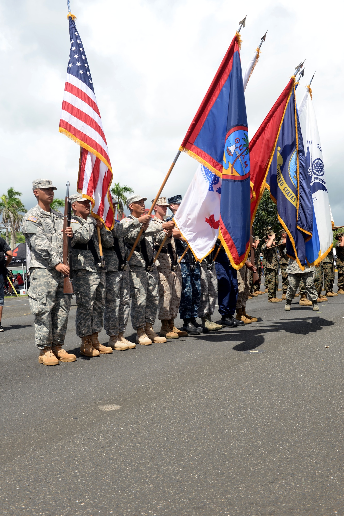 A joint service color guard presents the colors during the Liberation Day Parade July 21, 2015, in Hagåtña, Guam. The parade commemorated United States freeing the island from imperial Japan’s control during the Second Battle of Guam, which began July 21, 1944, and lasted 21 days. (U.S. Air Force photo by Senior Airman Joshua Smoot/Released)