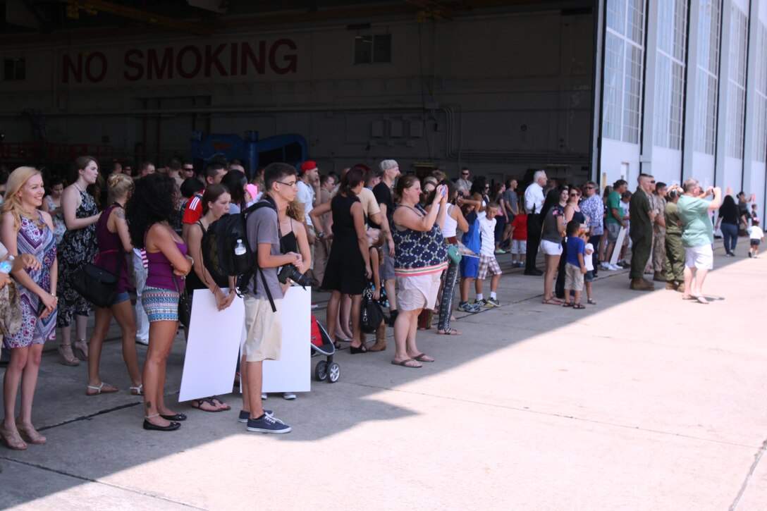 Families of the service members with Marine Aerial Refueler Transport Squadron 252 anxiously await for their loved ones return during a return celebration for the Marines VMGR-252 at Marine Corps Air Station Cherry Point, North Carolina, July 20, 2015. Eighty Marines arrived in VMGR-252’s hangar to meet their families for the first time in half a year, after returning from a deployment in Moron Air Base, Spain, maintaining readiness for crisis response in Africa.