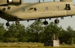 Two New York Army National Guard Soldiers from Company A, 427th Brigade Support Battalion, prepare to attach a sling-load to a CH-47 Chinook helicopter piloted by aviators from Company B, 3rd Battalion, 126th Aviation, July 19, 2015. The Soldiers, part of the 27th IBCT are at Fort Drum participating in an Exportable Combat Training Capability exercise in preparation of the Brigade’s rotation at the Joint Readiness Training Center at Fort Polk, La., scheduled for 2016.