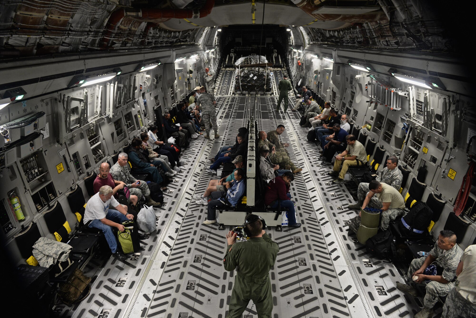 Wake Island Airfield staff and 36th Contingency Group Airmen prepare for departure in a C-17 Globemaster III July 20, 2015, at Andersen Air Force Base, Guam. A team with the 36th CRG deployed to Wake Island to assist in airfield storm recovery efforts after the atoll was evacuated a few days earlier in preparation of Typhoon Halole. (U.S. Air Force photo/Senior Airman Alexander W. Riedel)