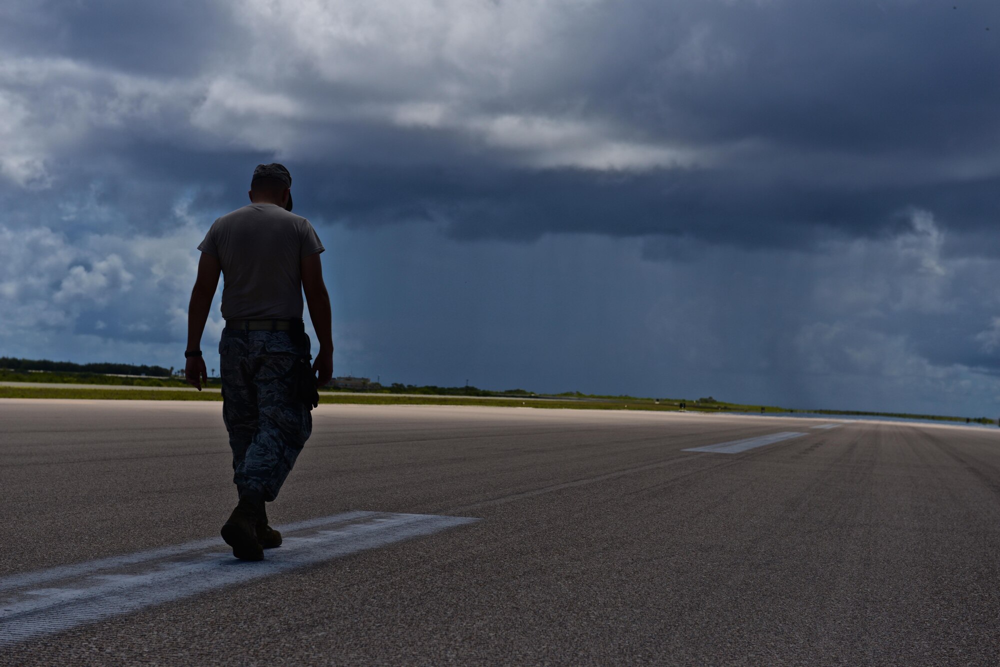 Capt. Clark Morgan, a 36th Mobility Response Squadron contingency engineer, surveys the pavement on Wake Island Airfield for cracks and other damage July 20, 2015, on Wake Island. A team with the 36th CRG at Andersen Air Force Base, Guam, deployed to the atoll to assist in airfield storm recovery efforts, and surveyed the runway to ensure adequate flightline safety. (U.S. Air Force photo/Senior Airman Alexander W. Riedel)