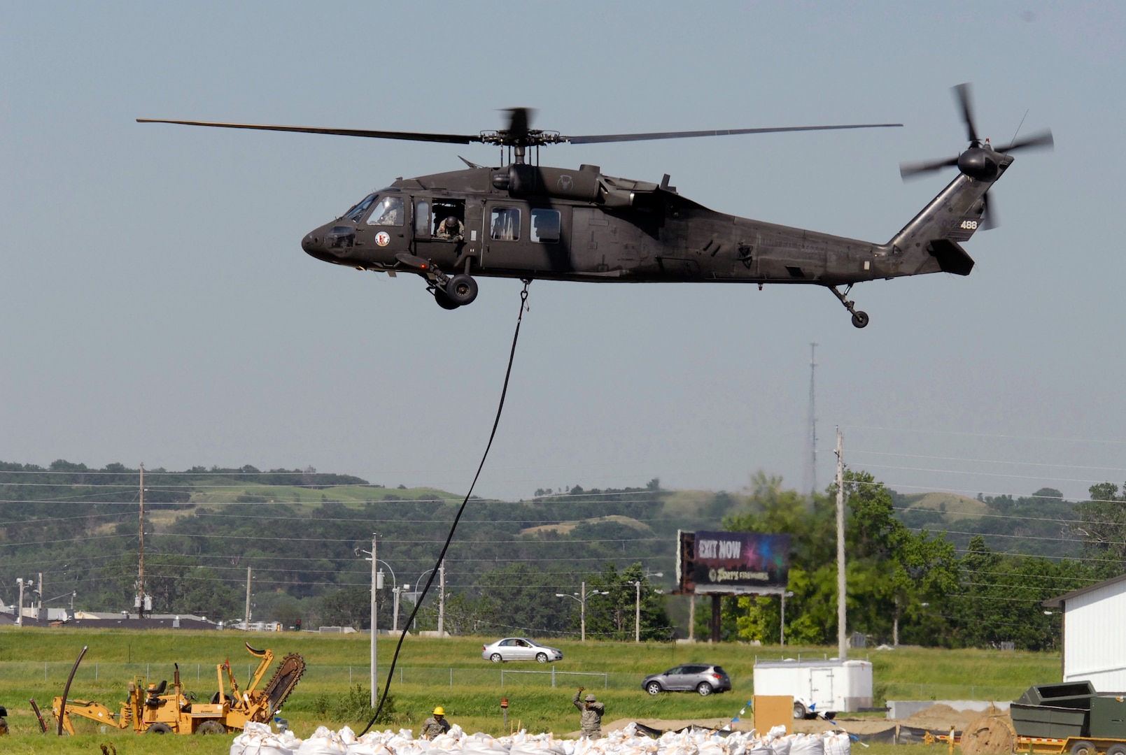 A UH-60 Black Hawk hooks on to a large bag of sand to deliver to residents
along the Missouri river June 8, 2011. Four UH-60 Black Hawk helicopters from
the Minnesota and Iowa National Guard and a CH-47 Chinook from the Illinois
Army National Guard have been providing support by delivering sandbags to
many of the critical areas along the river and by monitoring critical areas
along the coast line. Over 400 National Guard members have been activated to
provide support to many of the communities along the Missouri who are in danger of flooding. 