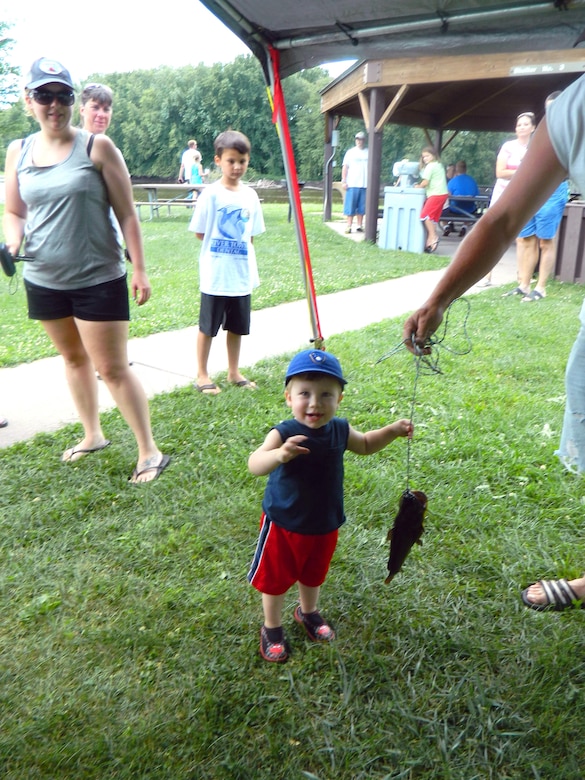 A young angler registers his fish during the 2013 Blackhawk Park Kids Fishing Derby.