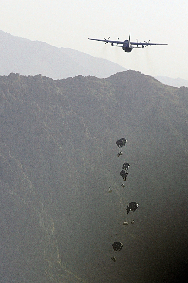 A C-130 Hercules from the New York Air National Guard airdrops much-needed supplies to a forward operating base in Oruzgan Province, Afghanistan, June 22, 2011. The New York ANG C-130 flew the airdrop mission in conjunction with another C-130 from the Alaska ANG. Airdrops help mitigate the danger of transporting supplies via convoy.