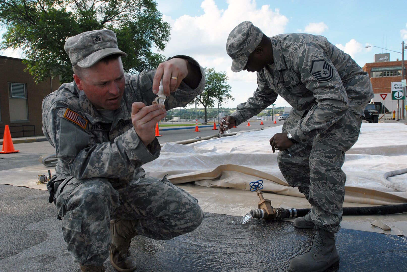 Army Sgt. Burton Atkinson, a water purification noncommissioned officer from the 132nd Quartermaster Company, North Dakota National Guard, tests samples of water that his team purified June 26, 2011 in Minot, N.D. His team of water purification specialists are working to create safe and sterile water for the local hospital after civilian officials sent out a boil order for residents of the flooded city.
